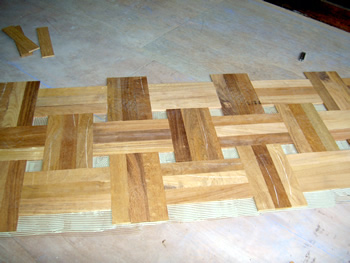New parquet wood flooring in Stamford Hill. Merbau parquet wood floor in basket weave pattern with small oak dot..