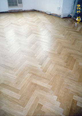 New parquet floor in Lambeth, London. We installed this new european oak parquet wood floor in a herringbone pattern with a two line border in mahogany.  .
