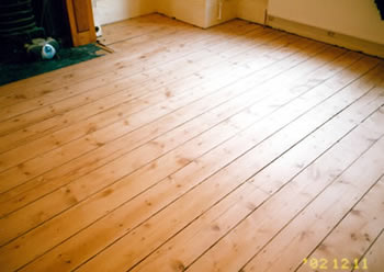 Pine floor board stripping in Watford. We stripped and sanded these existing pine floorboards..